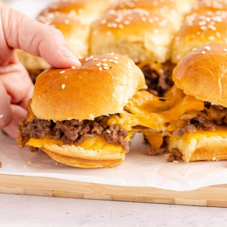 Cheeseburger Sliders with cheese pulling from one to another