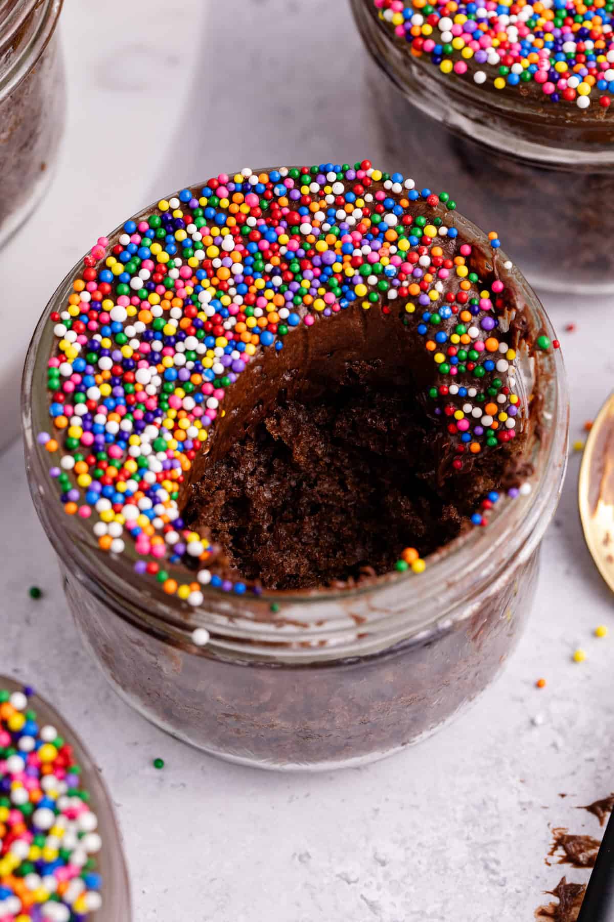 Chocolate Viral Dot Cake in a small jar with a scoop taken out
