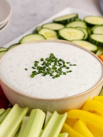 Cottage Cheese Ranch Dip in a serving bowl with vegetables all around