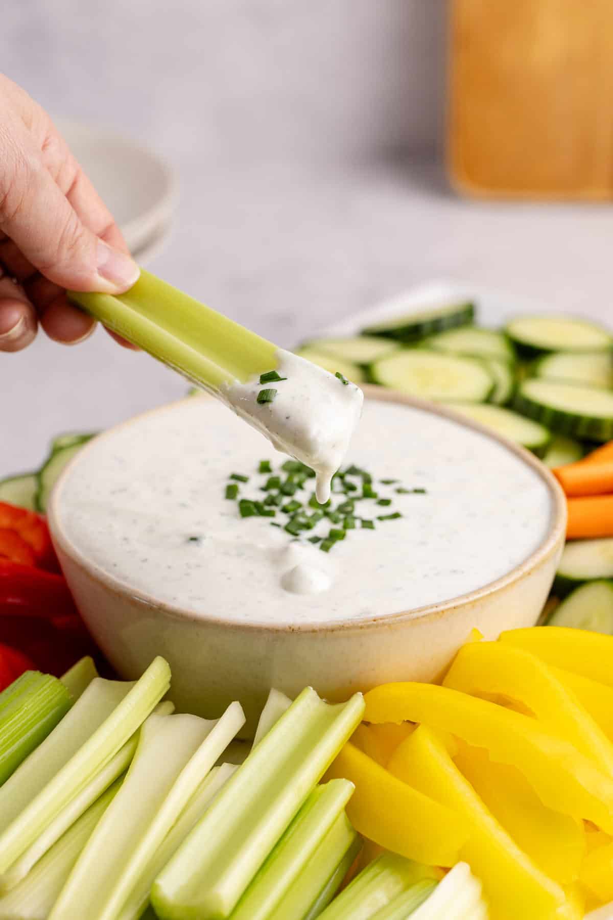 Cottage Cheese Ranch Dip in a serving bowl with a celery stick dipping in
