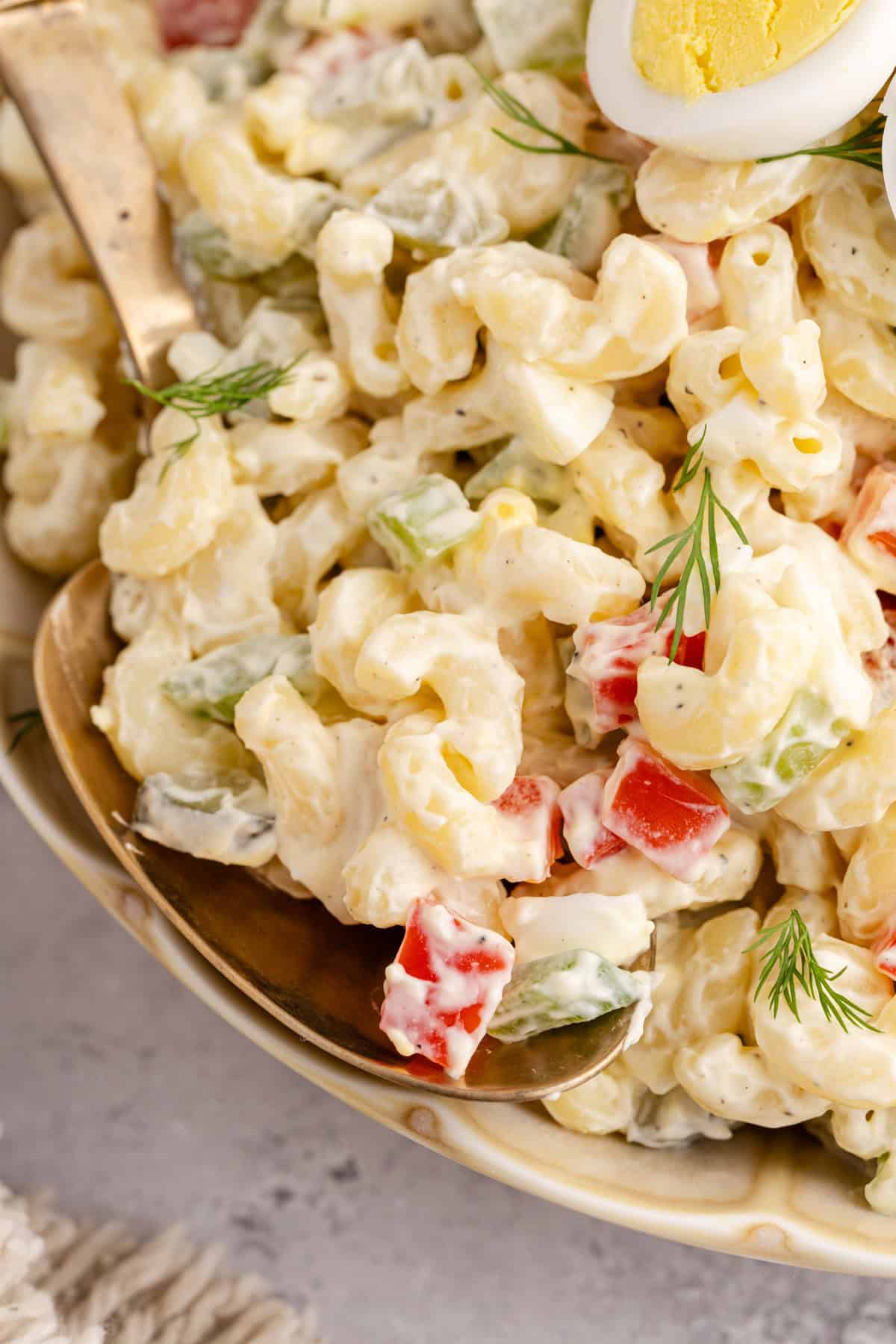 Macaroni Salad up close on a serving spoon