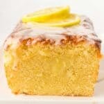 Old Fashioned Lemon Pound Cake sliced to show the moist inside with lemon slices on top