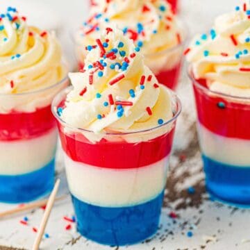 Red, White, and Blue Jello Cups up close with sprinkles and whipped cream