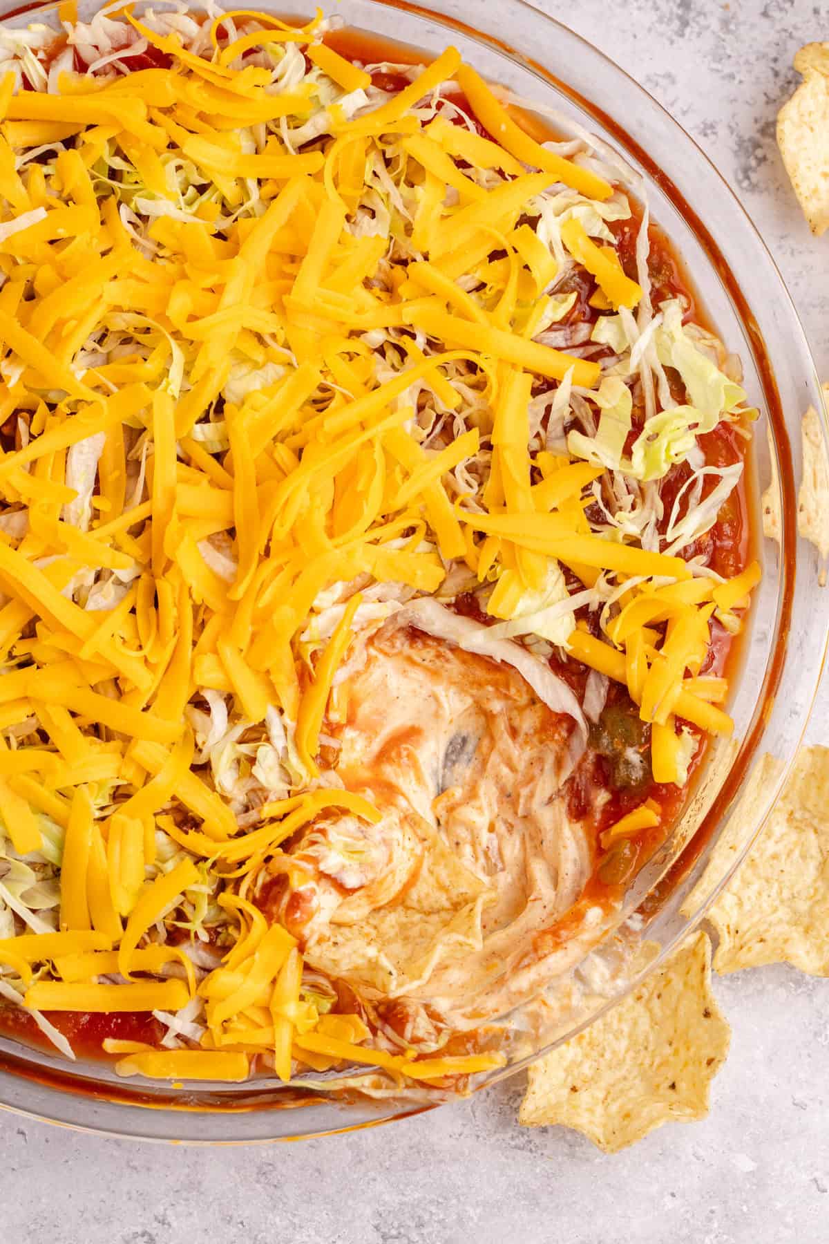 Taco Dip with Cream Cheese in a glass serving dish from overhead