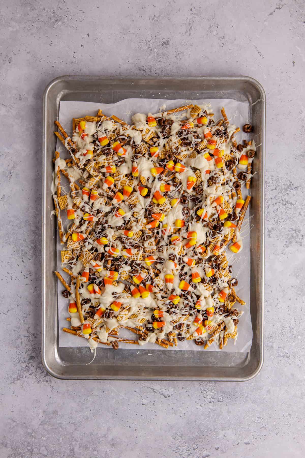 candy corn crunch bark on parchment paper on a large baking sheet