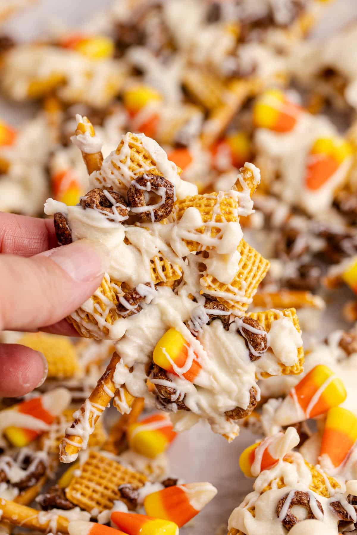 hand holding piece of candy corn crunch bark