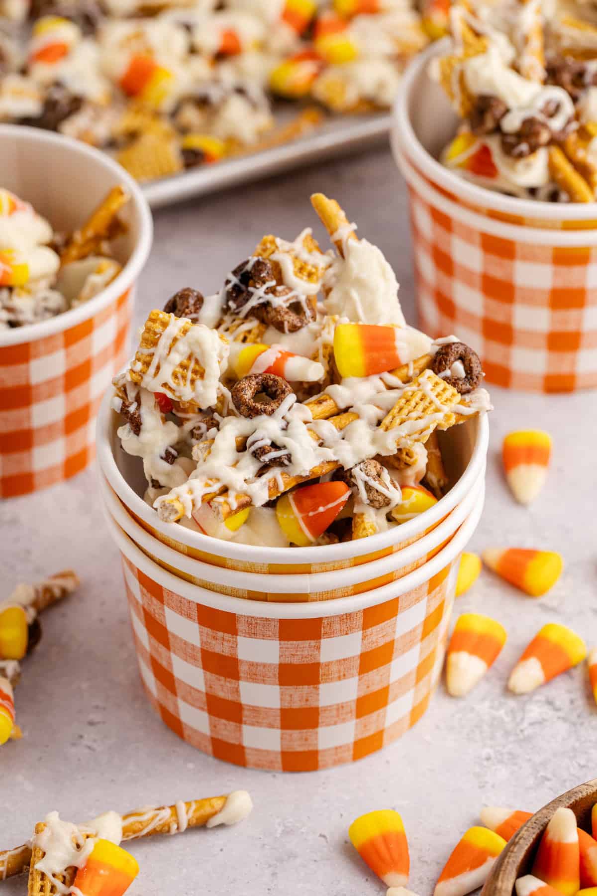 candy corn crunch bark pieces inside a plaid paper cup