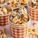 candy corn crunch bark pieces inside a plaid paper cup