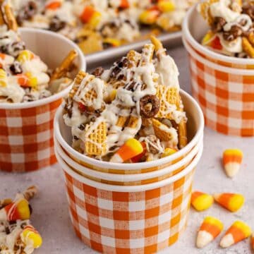 candy corn crunch bark pieces inside a plaid paper cup