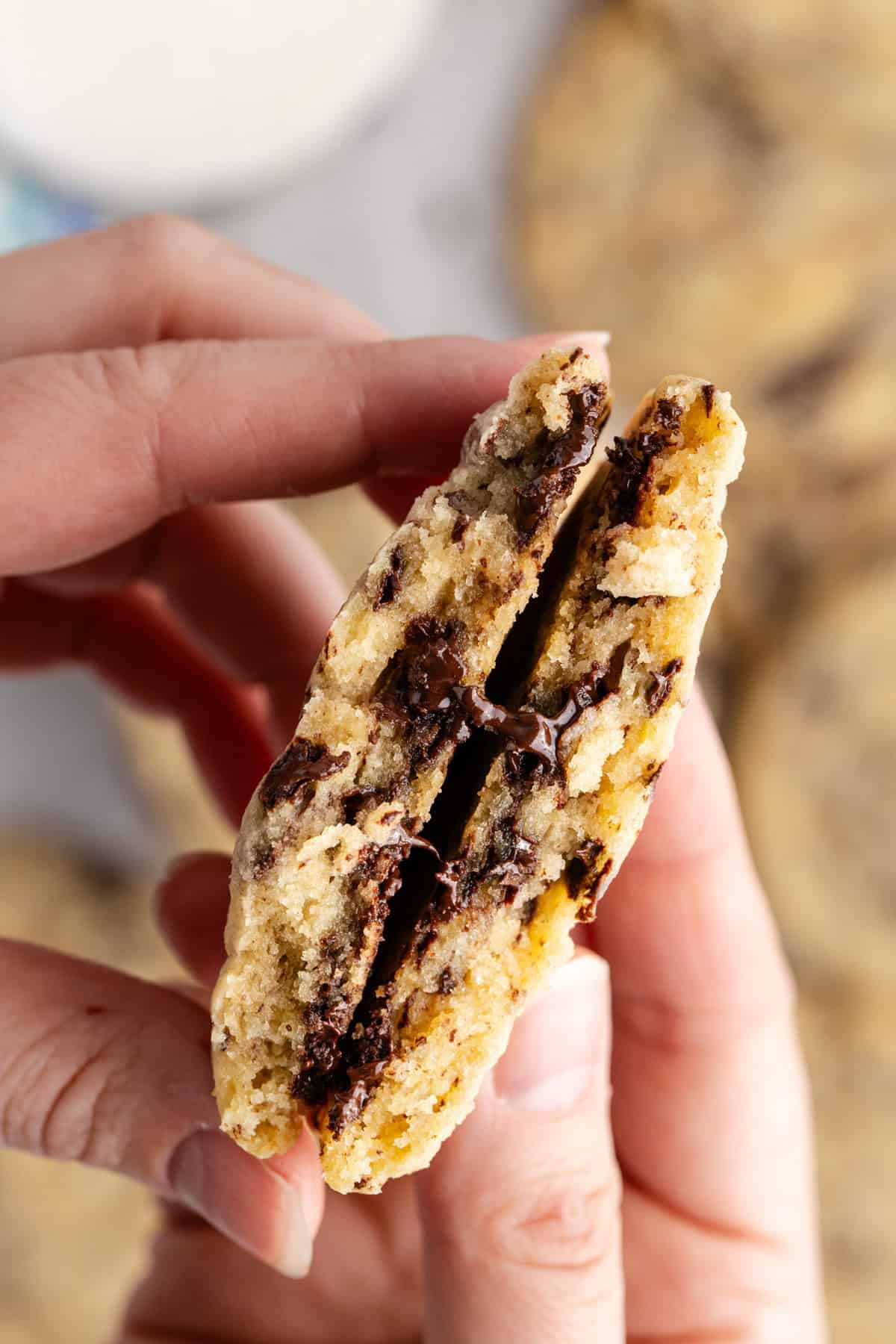 Chocolate Chip Vanilla Pudding Cookies broken in half showing the melted inside