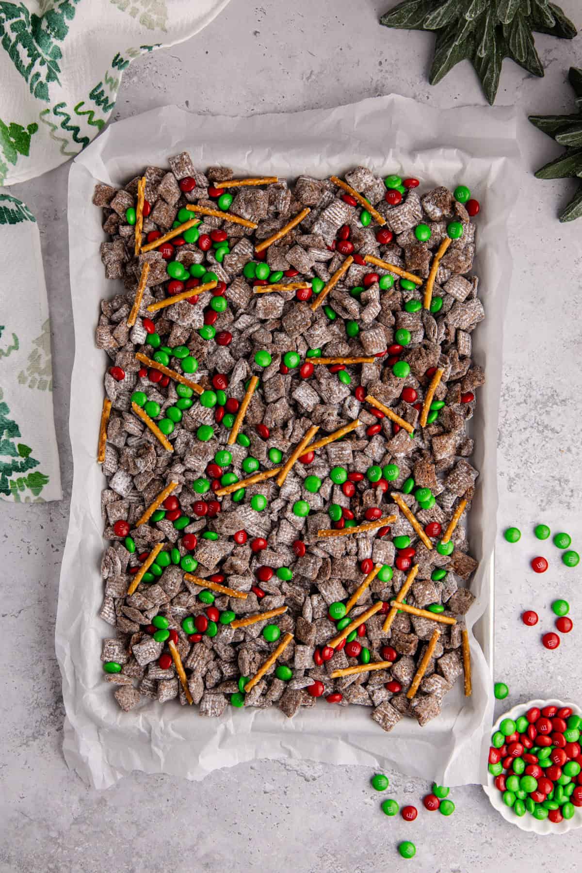 Christmas Puppy Chow all mix on a baking sheet