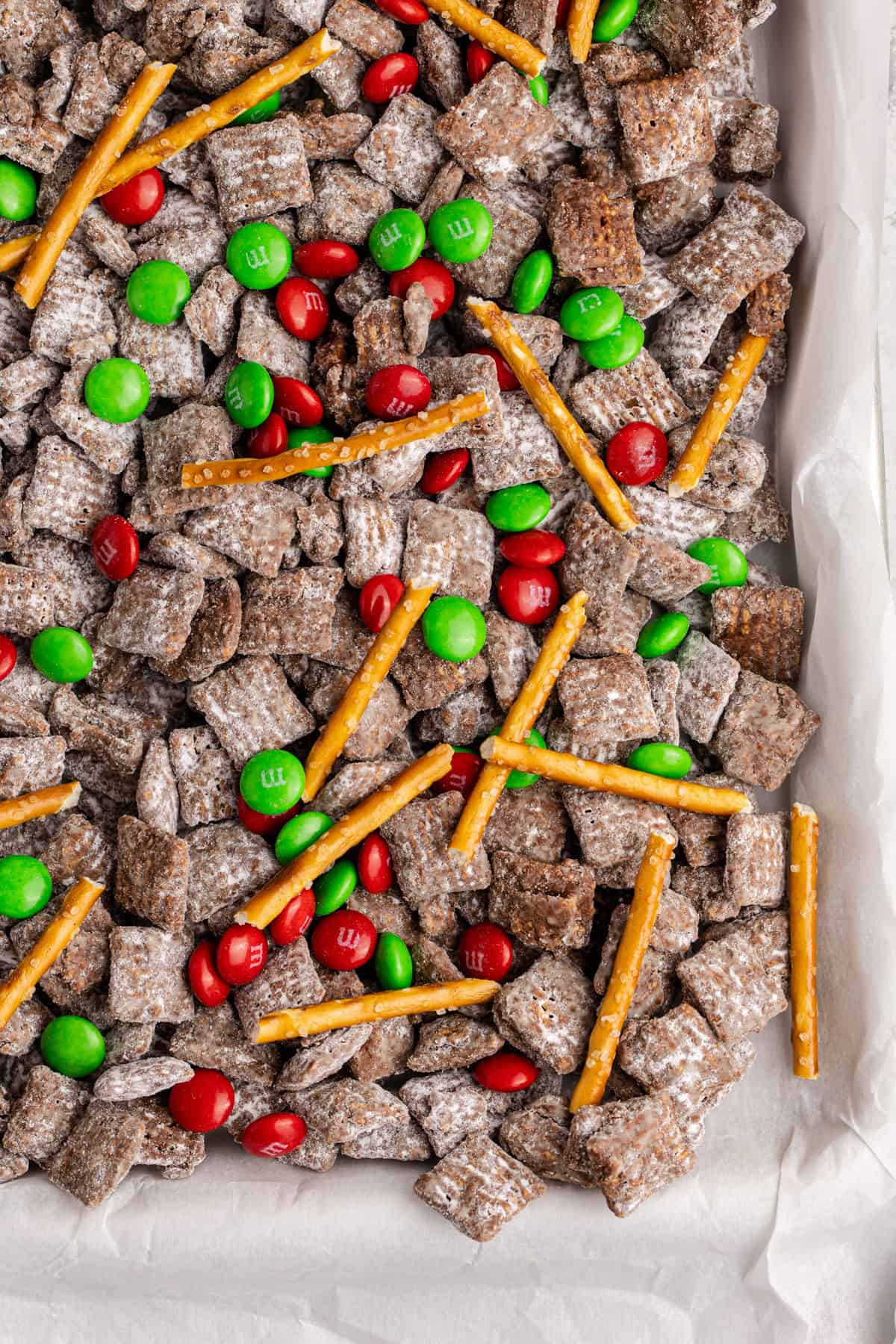 Christmas Puppy Chow up close on a baking sheet