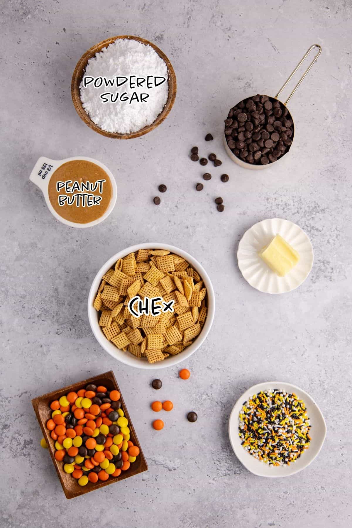 Halloween Puppy Chow ingredients on a counter