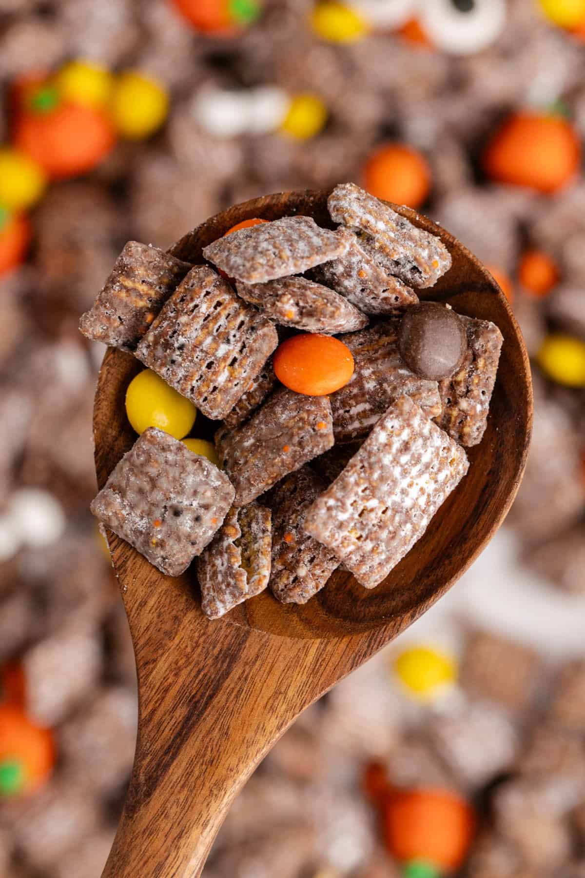 Halloween Puppy Chow from above on a serving spoon
