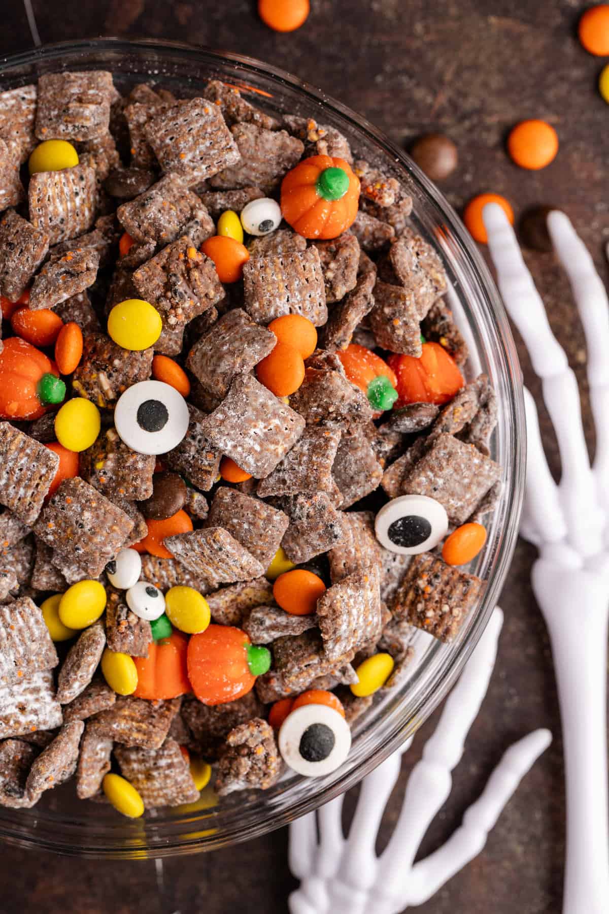 Halloween Puppy Chow in a bowl from above with candy eyeballs