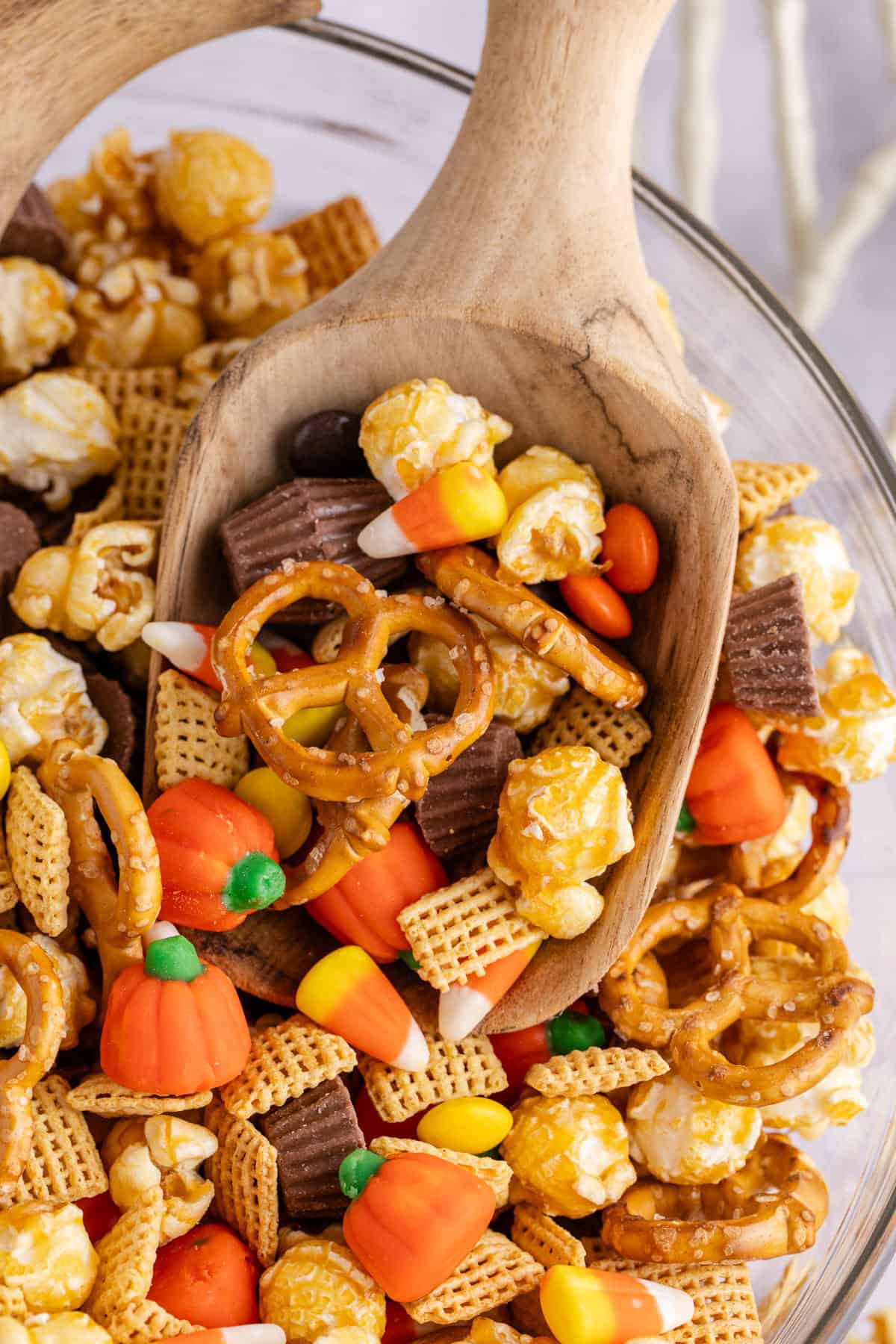 wooden scoop in a bowl of halloween snack mix