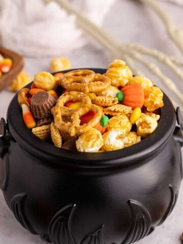 halloween snack mix served in black cauldron bowl
