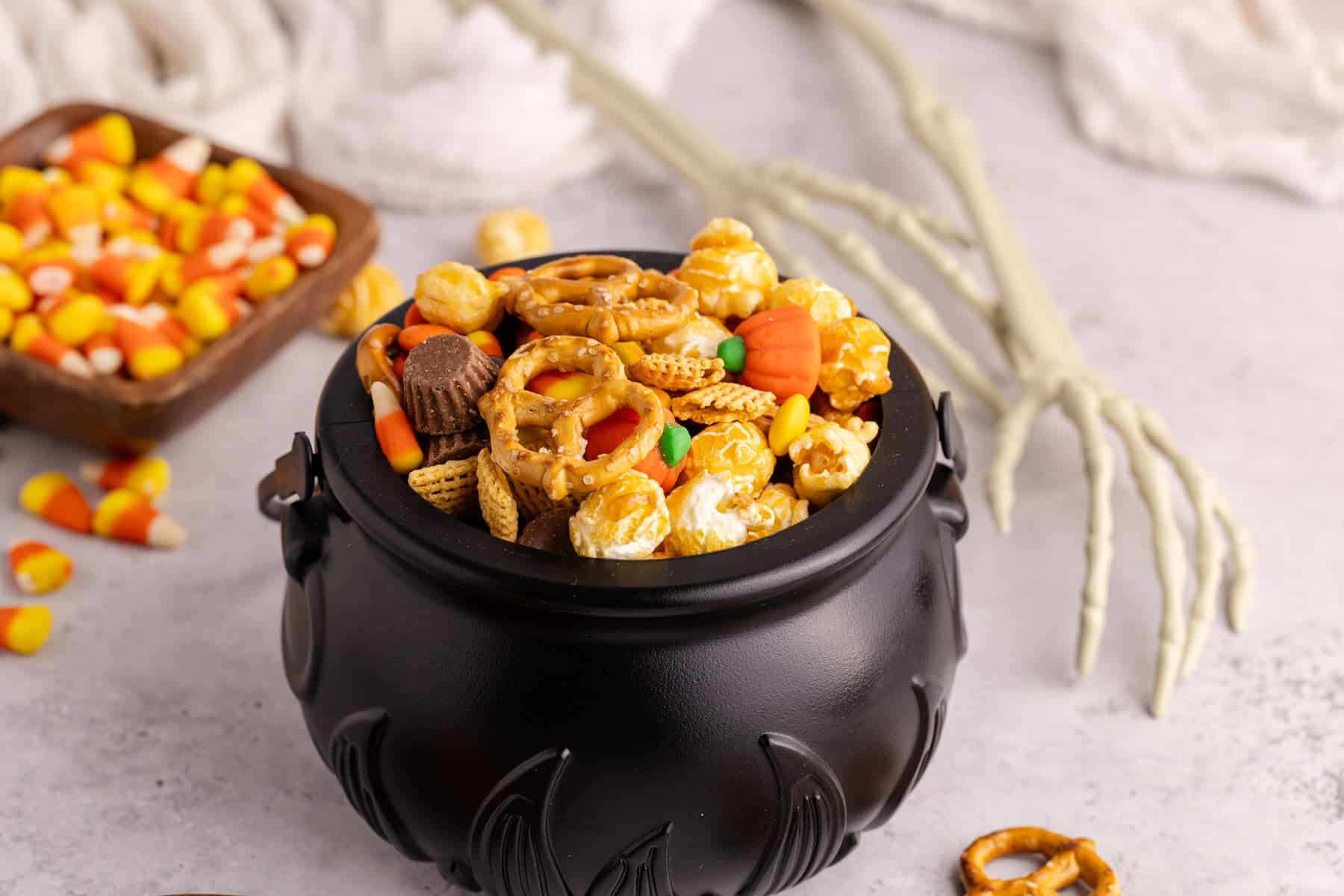 halloween snack mix served in black cauldron bowl