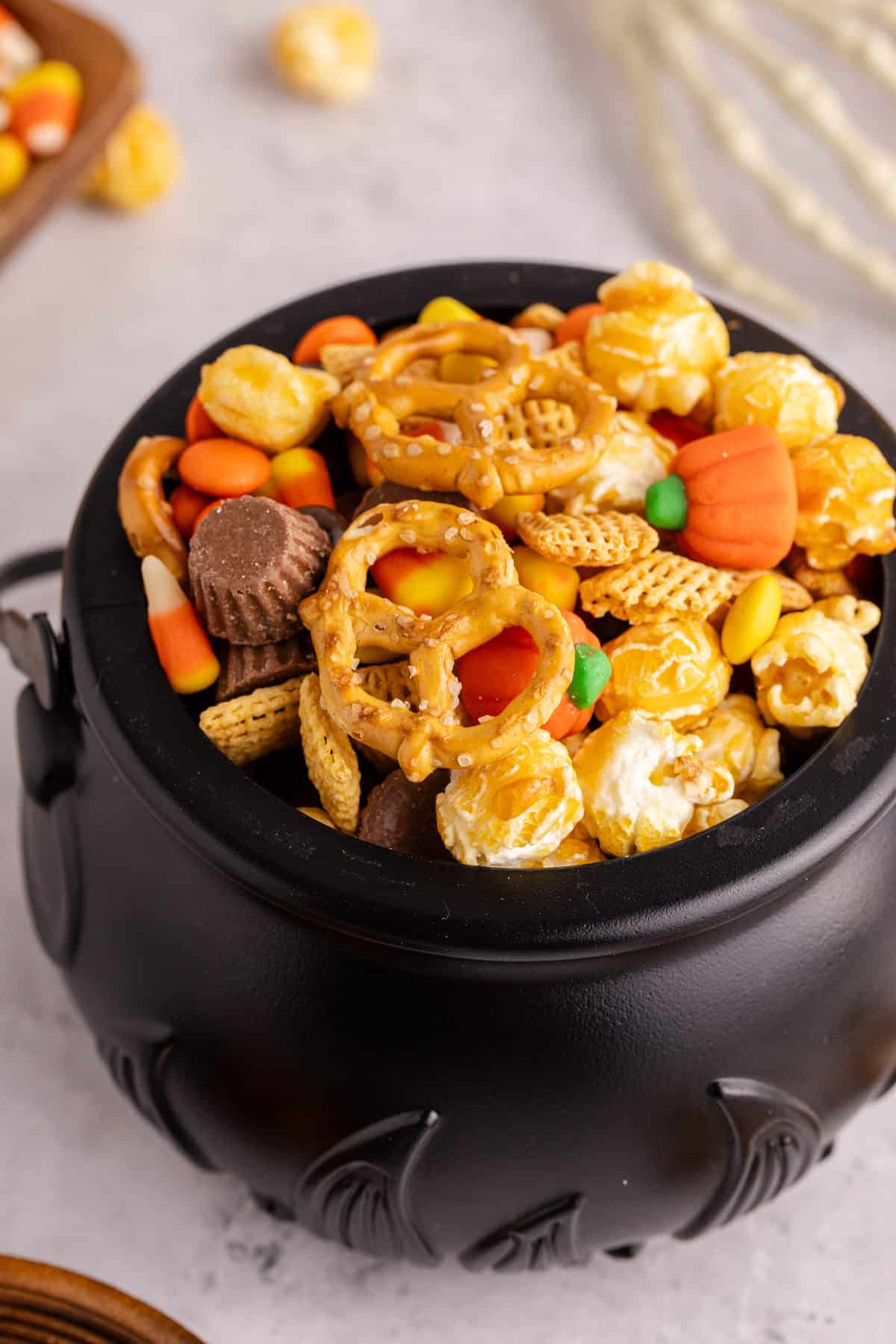 halloween snack mix served in black cauldron bowl