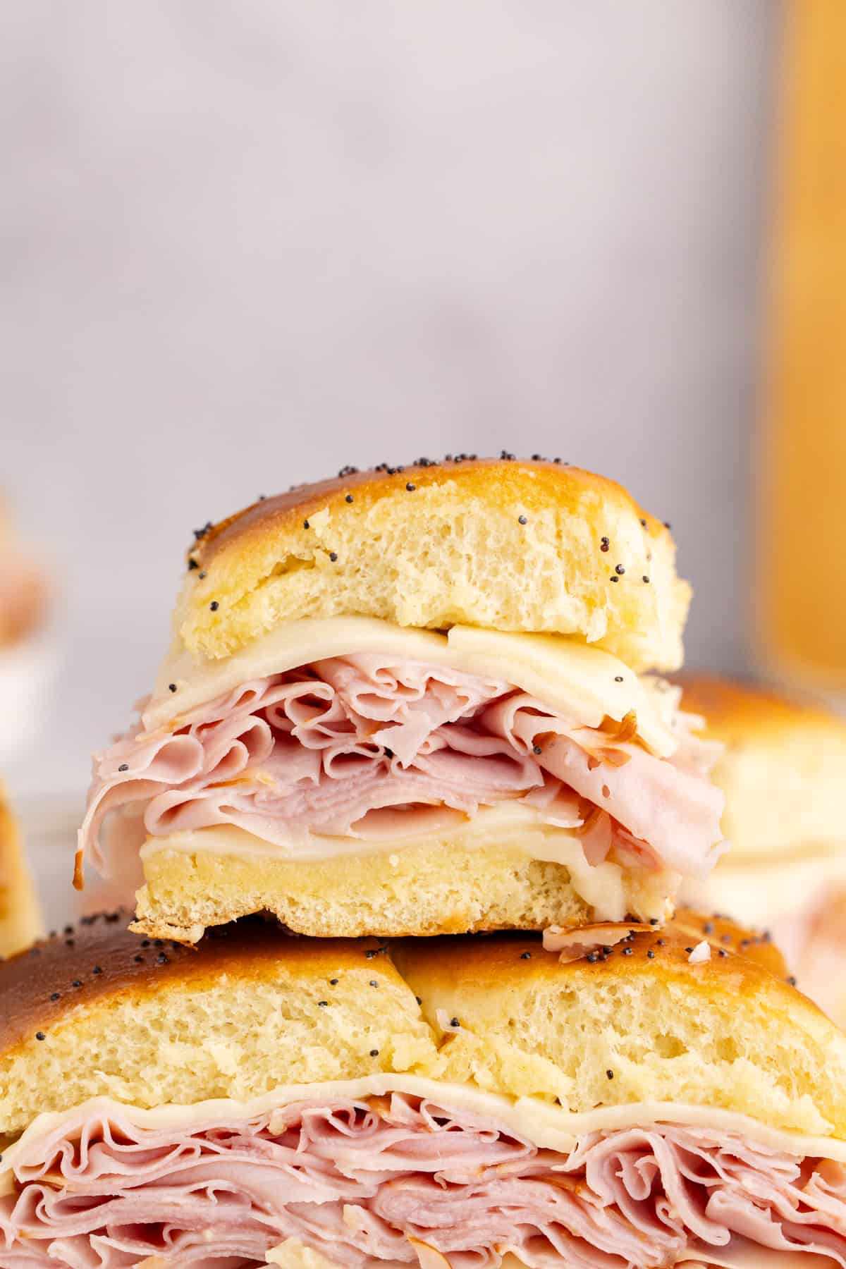 stacked ham and swiss cheese on hawaiian roll buns