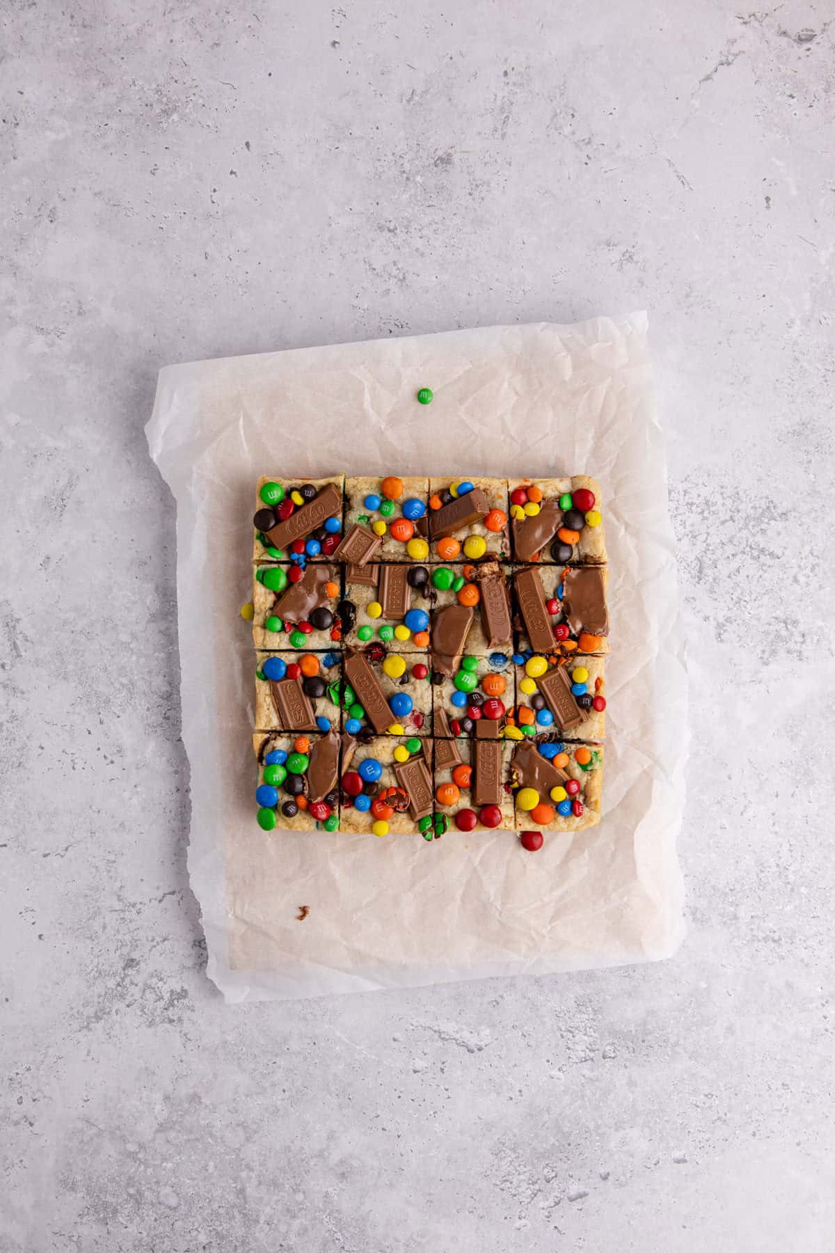 Leftover Candy Cookie Bar from above after cooling on parchment paper