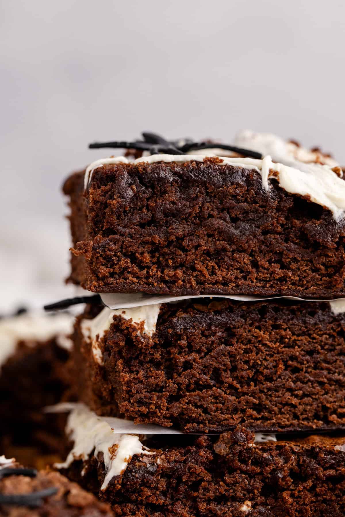 Spiderweb Brownies stacked up close to see the texture
