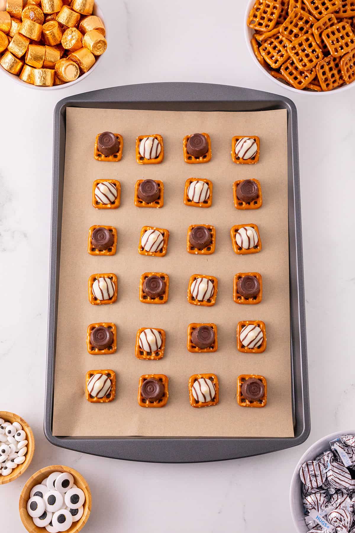 Monster Eye Pretzel Treats being made on a cookie sheet