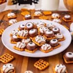 Monster Eye Pretzel Treats on a plate with more pretzels around