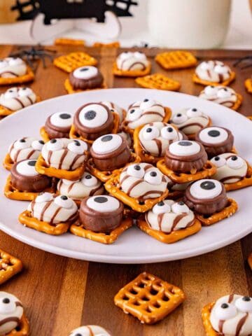 Monster Eye Pretzel Treats on a plate with more pretzels around