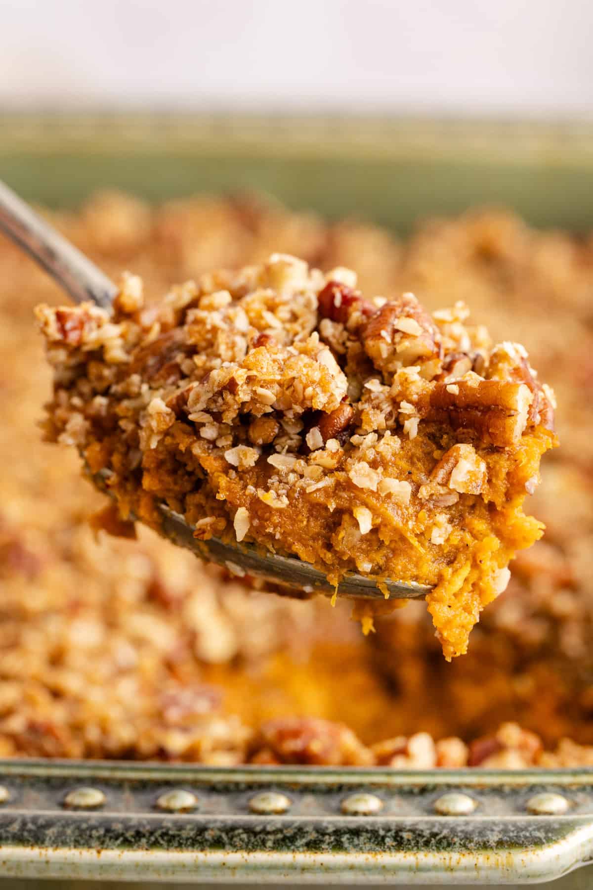 Sweet Potato Casserole with Pumpkin on a serving spoon up close