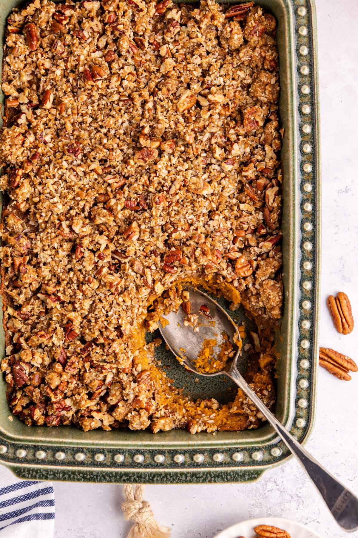 Sweet Potato Casserole with Pumpkin from above baked in the dish with a serving spoon