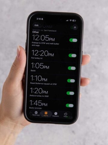 A phone being held with a set of timers on it