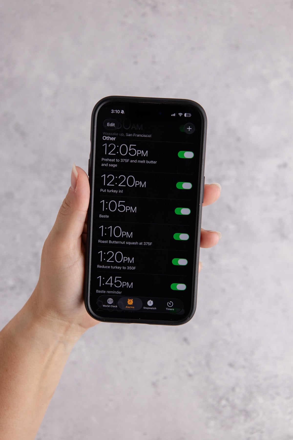 A phone being held with a set of timers on it