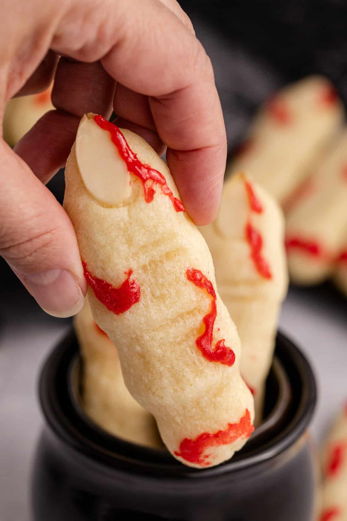 Witch Finger Cookies being picked up, shown up close
