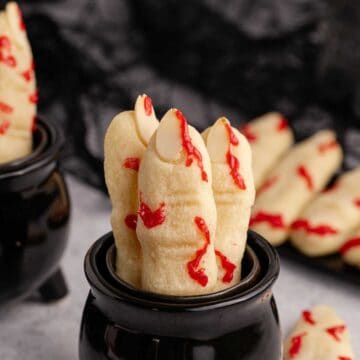 Witch Finger Cookies in a black cauldron with blood on them