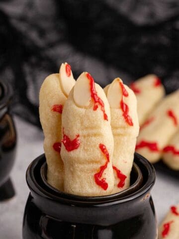 Witch Finger Cookies in a black cauldron with blood on them