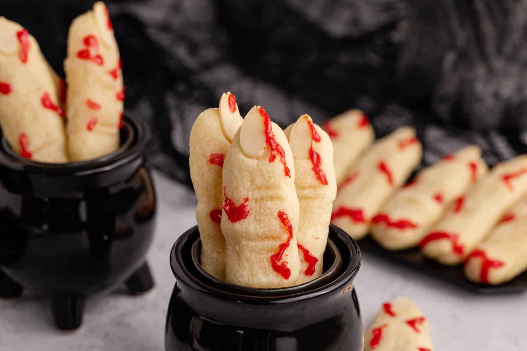 Witch Finger Cookies in a black cauldron with blood on them