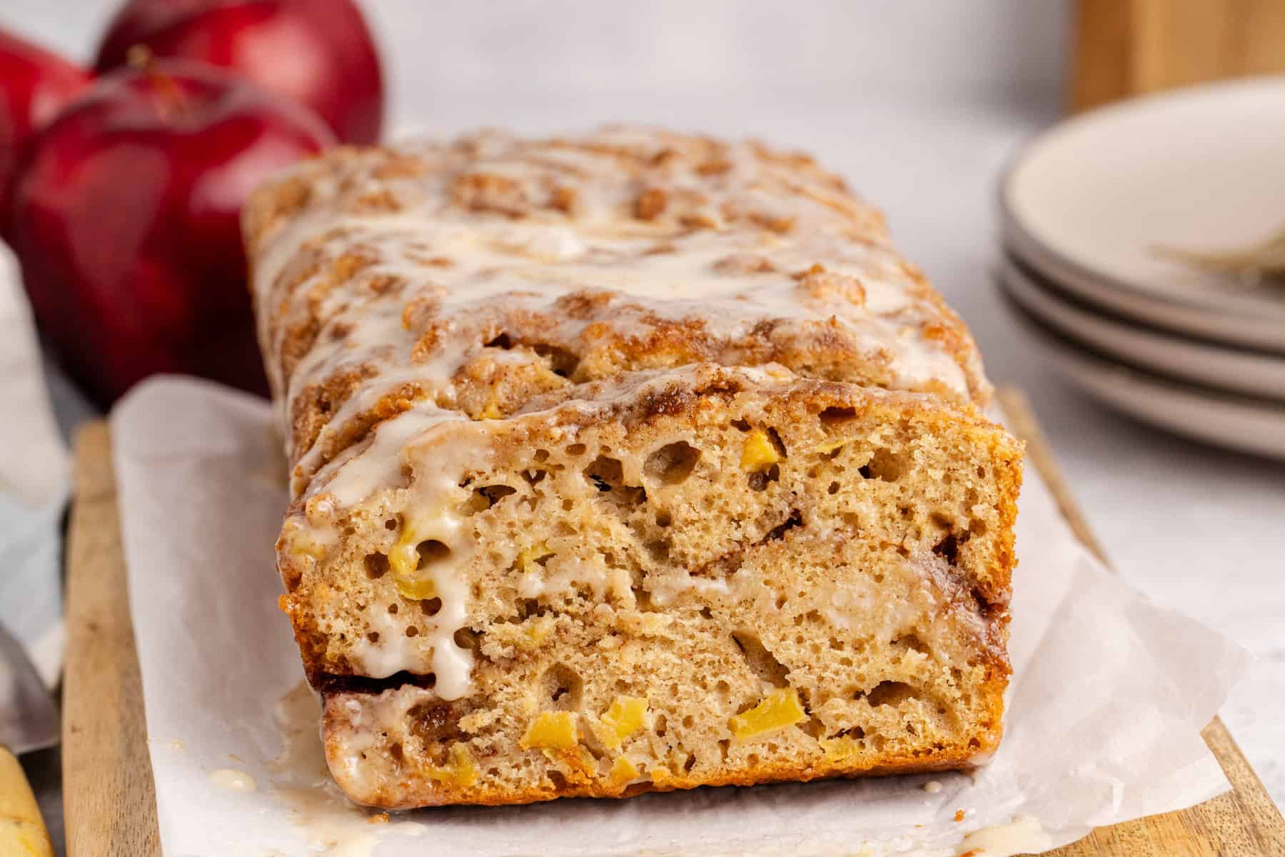 Apple Fritter Quick Bread with sliced leaned up again the loaf