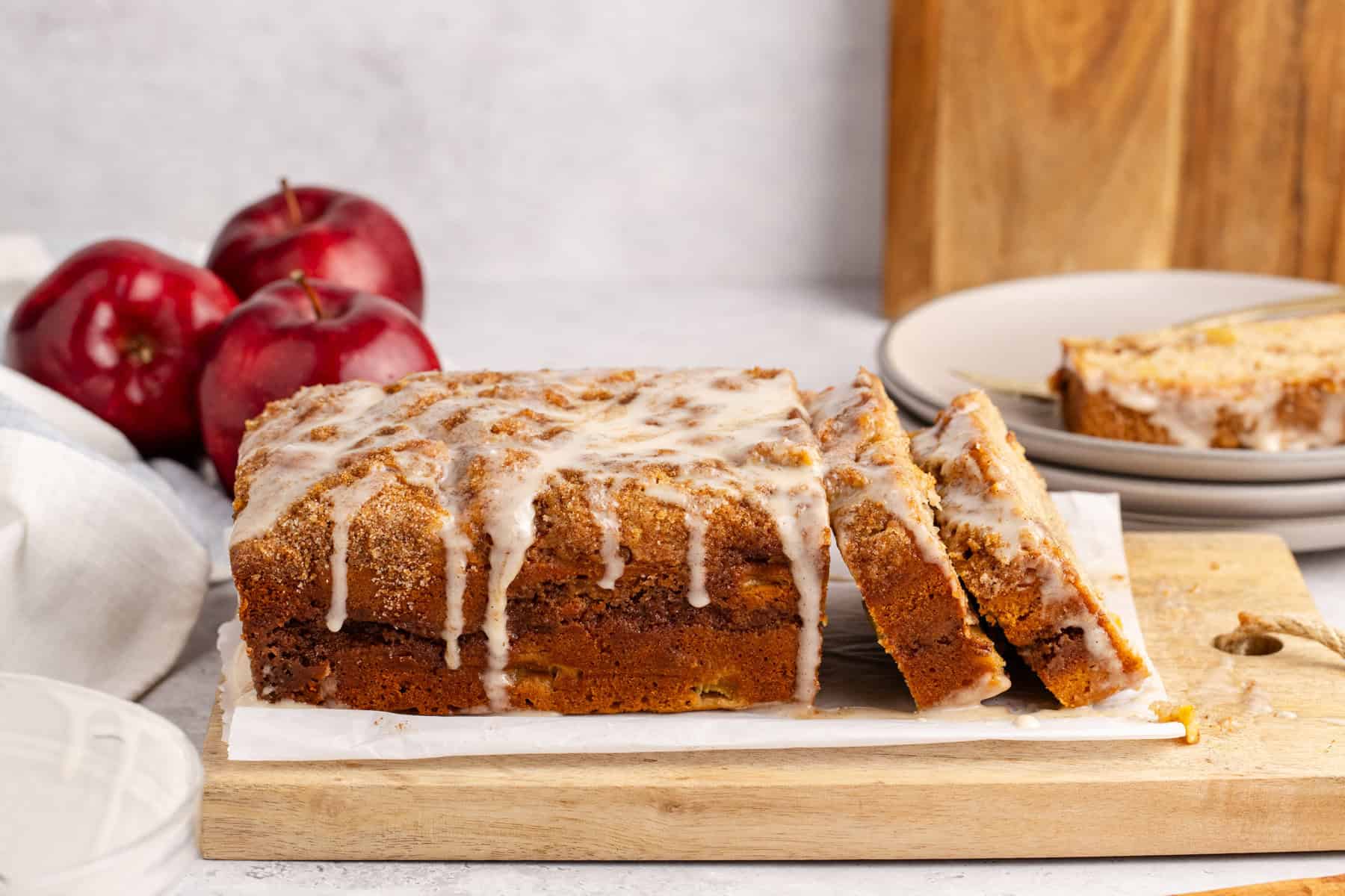 Apple Fritter Quick Bread from the side to see all the dripping glaze