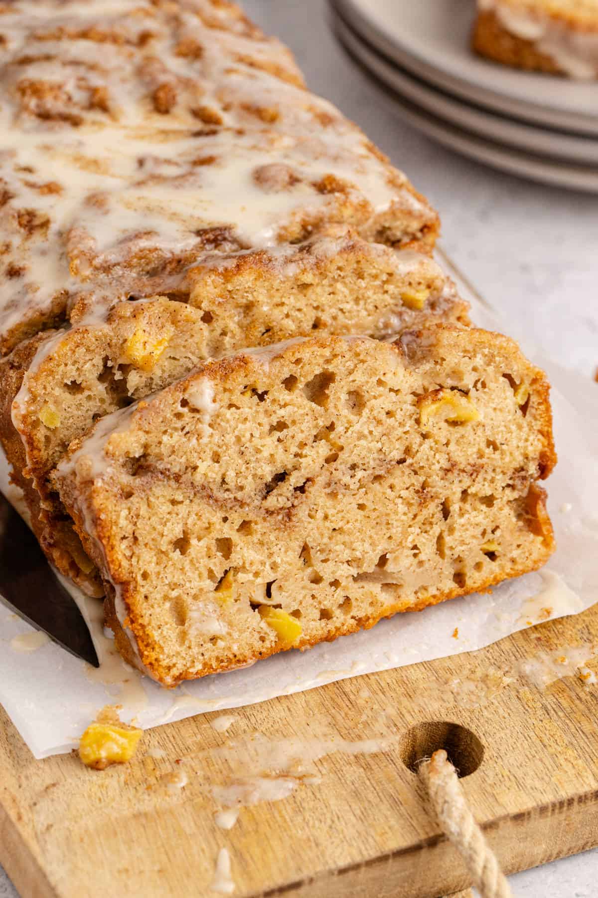 Apple Fritter Quick Bread slice up close to see the fruit and cinnamon swirl