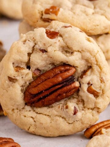 Butter Pecan Cake Mix Cookies stacked with one cookie leaning against it
