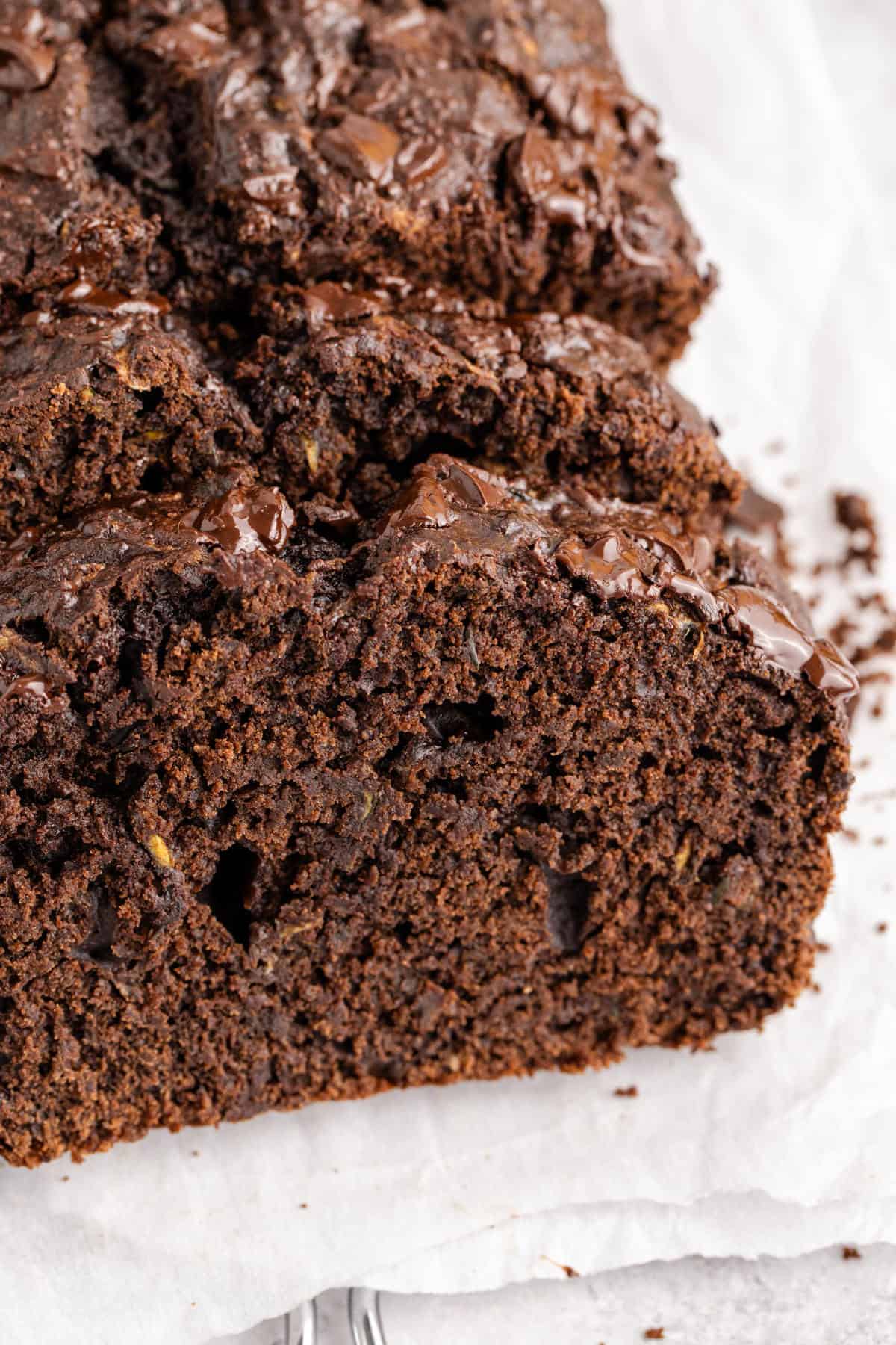 Chocolate Zucchini Loaf with slices laying up against it