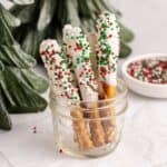 Christmas Pretzel Rods with red, white and green sprinkles in a small jar