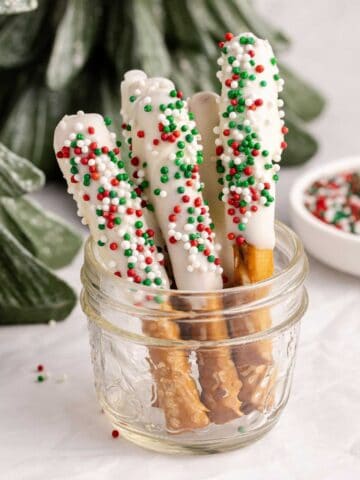 Christmas Pretzel Rods with red, white and green sprinkles in a small jar