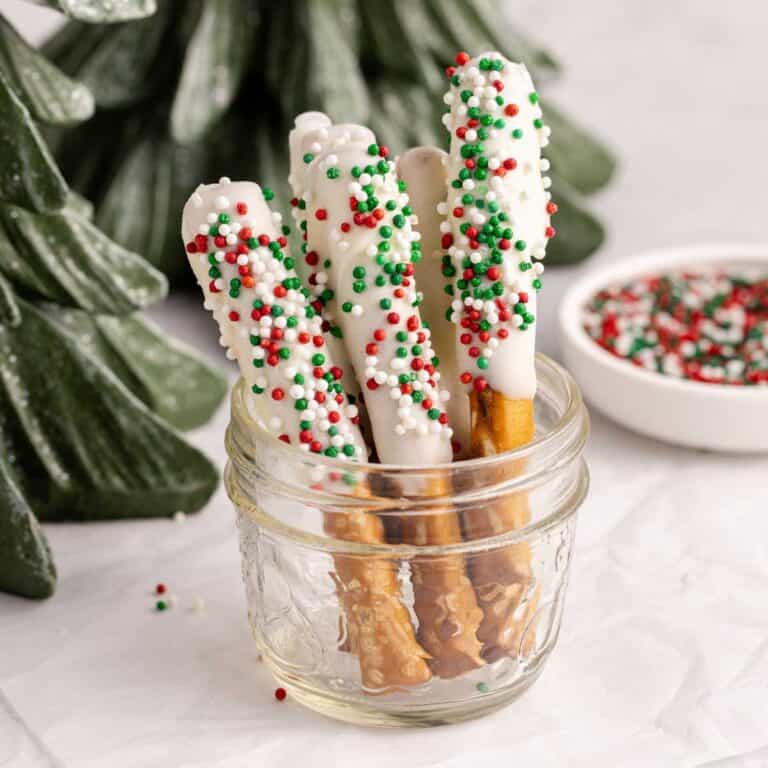 Christmas Pretzel Rods with red, white and green sprinkles in a small jar