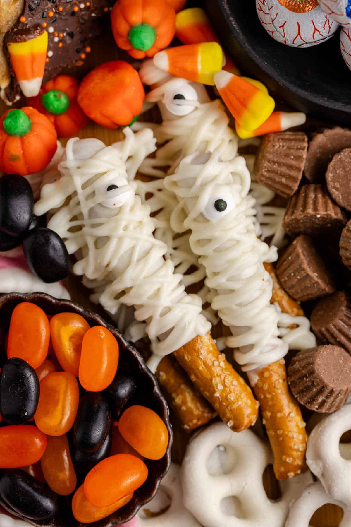 Close up of Mummy Pretzel Rods on a Dessert Board