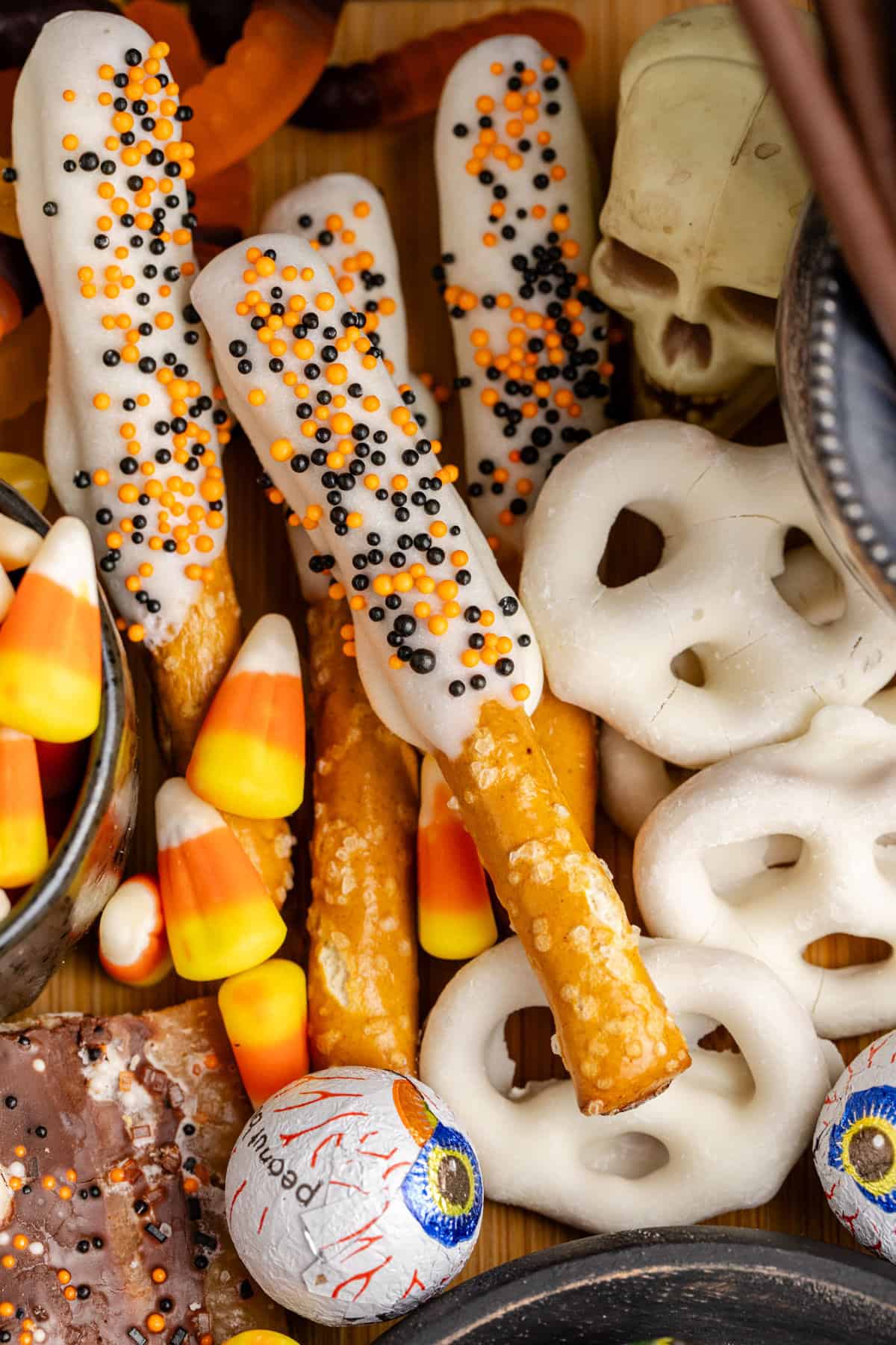 Halloween Pretzel Rods on a Dessert Board with other candies