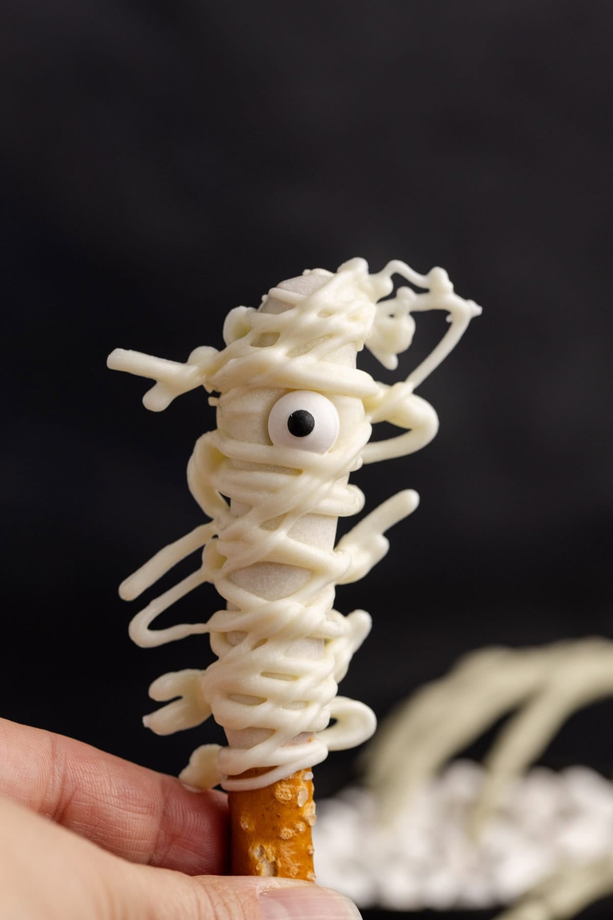 Mummy Pretzel Rod being held up close