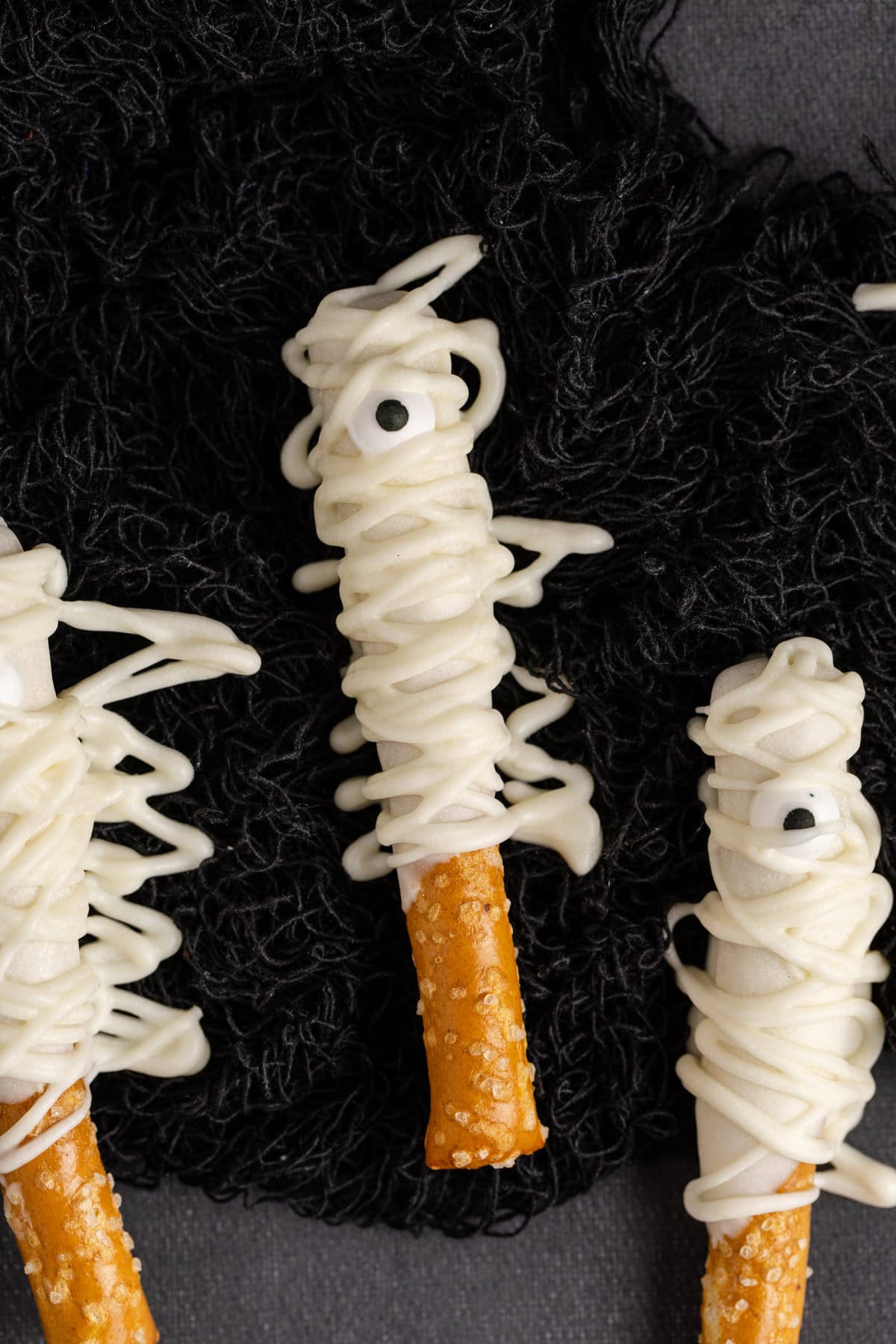 Mummy Pretzel Rods up close on black cloth