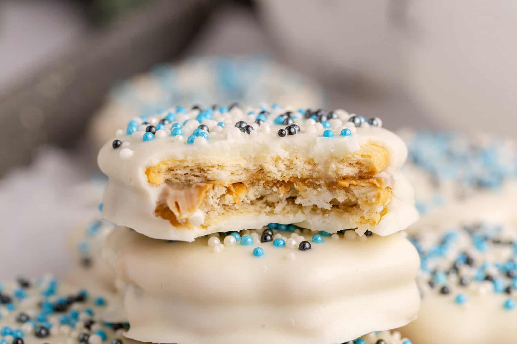 White Chocolate Ritz Cracker Cookies stacked with a bite taken